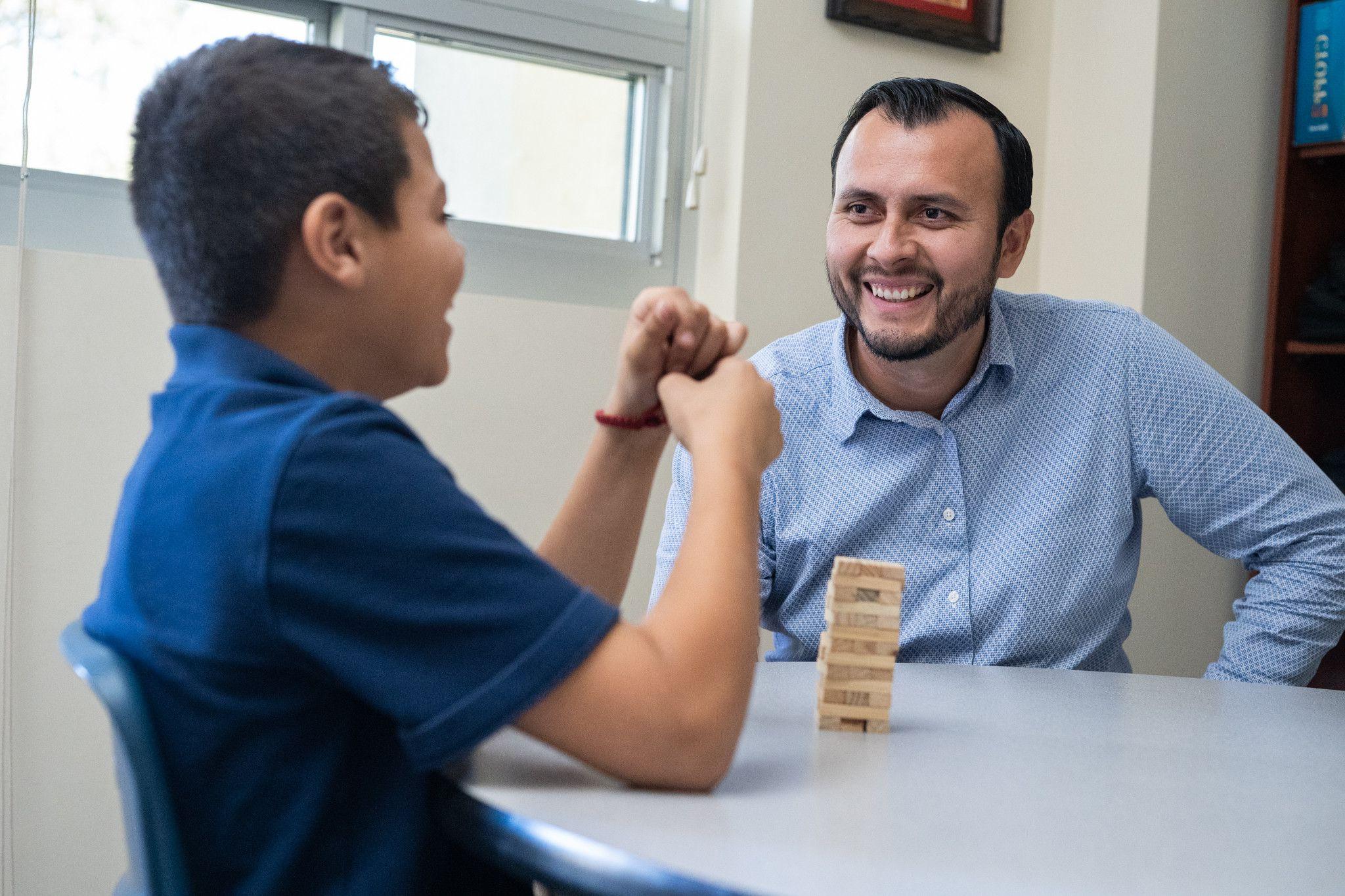 teacher with student at table